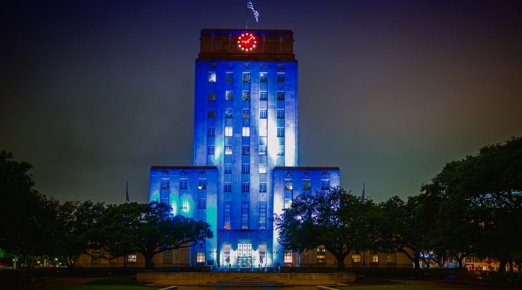 A City Hall lit up in blue and white
