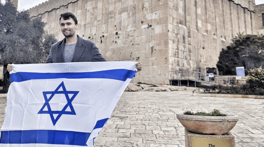 A photo of Charlie Kirk holding an Israeli Flag in Hebron.