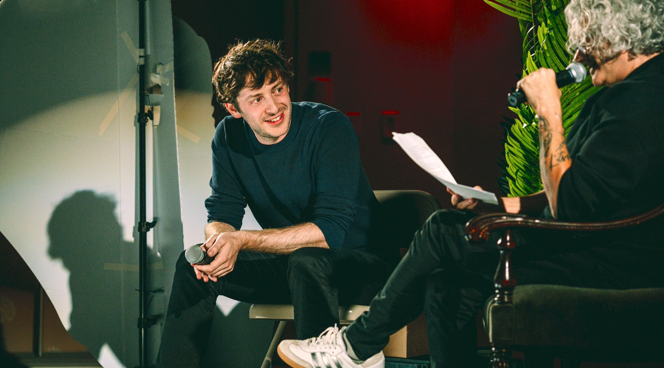 A comedian and an author share a laugh on stage.
