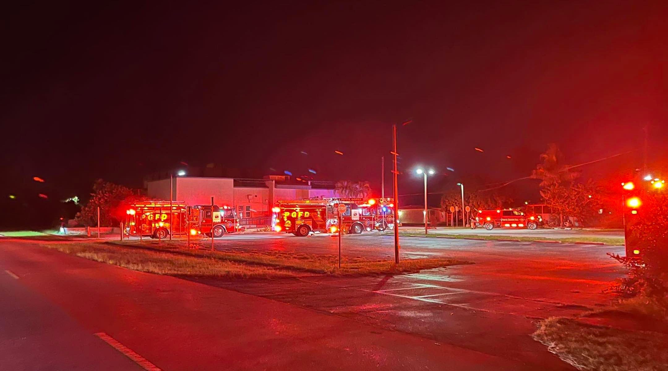 A photo of fire trucks with red lights.
