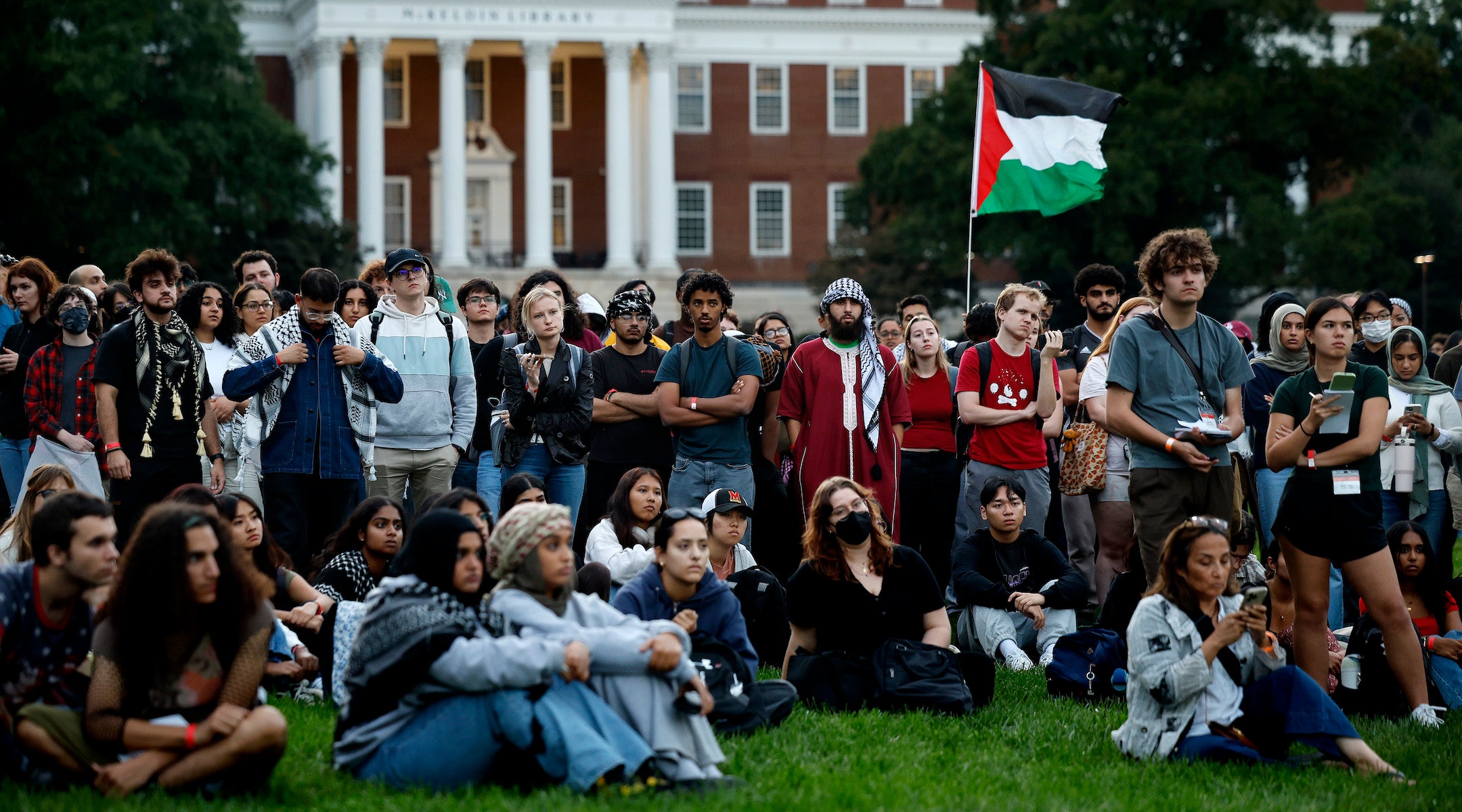 A group of pro-Palestinian protesters with a Palestinian flag.